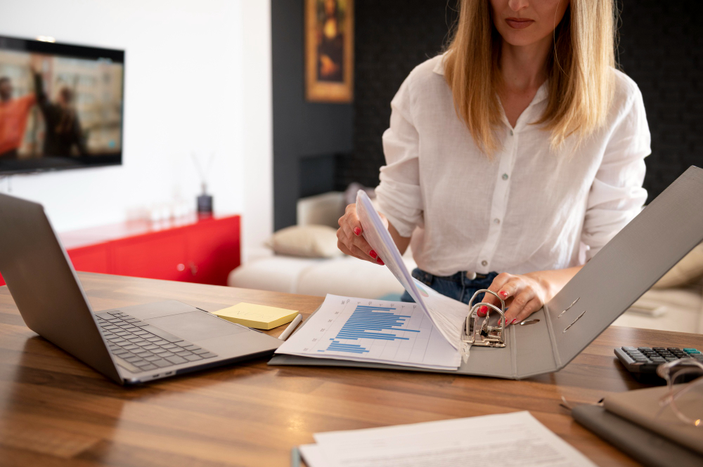 woman arranging a file - Outsourced Payroll Services