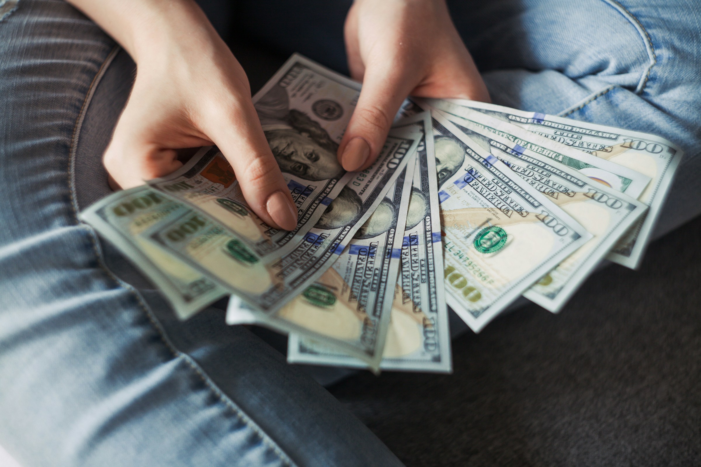 Person Holding Money - Solutions for Equal Pay