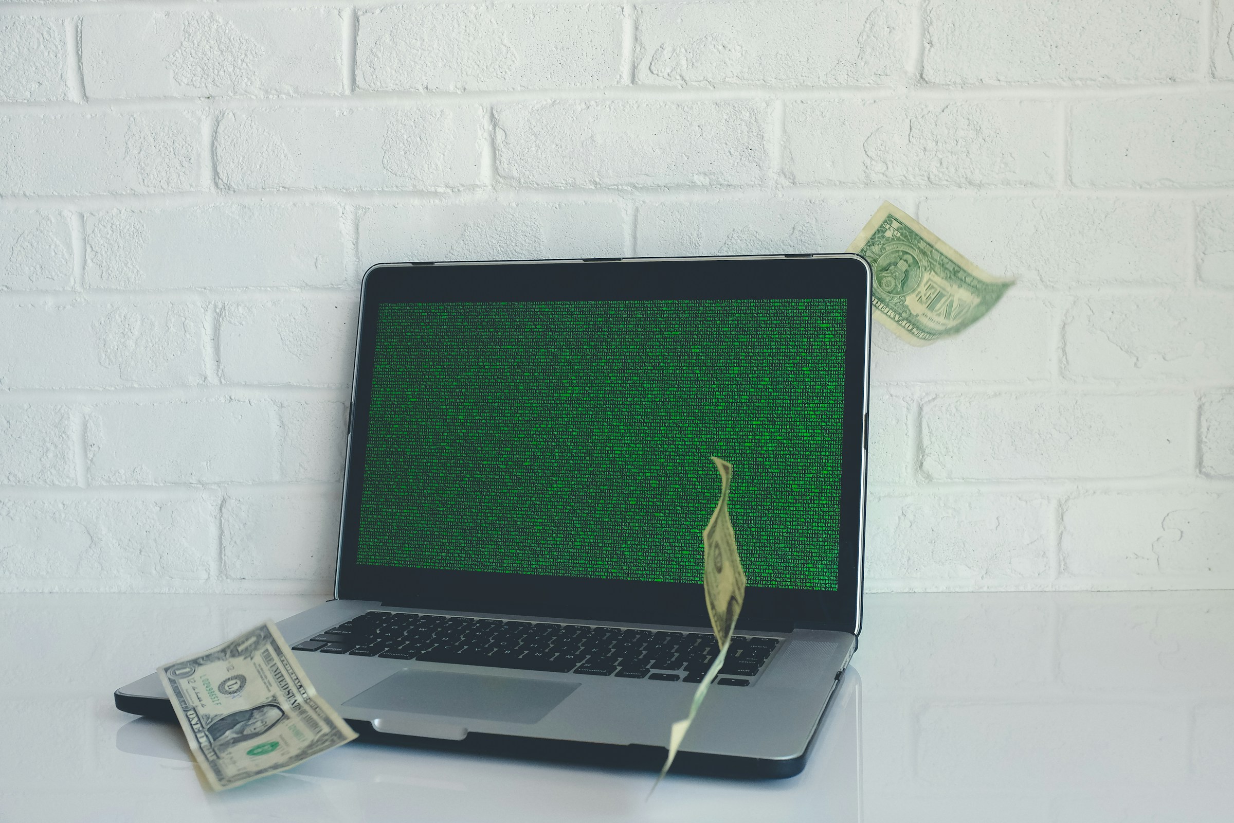 Money Laying on Laptop - Solutions for Equal Pay